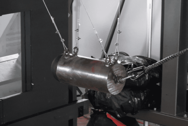 100 pound steel impactor hitting glass with security window film on it